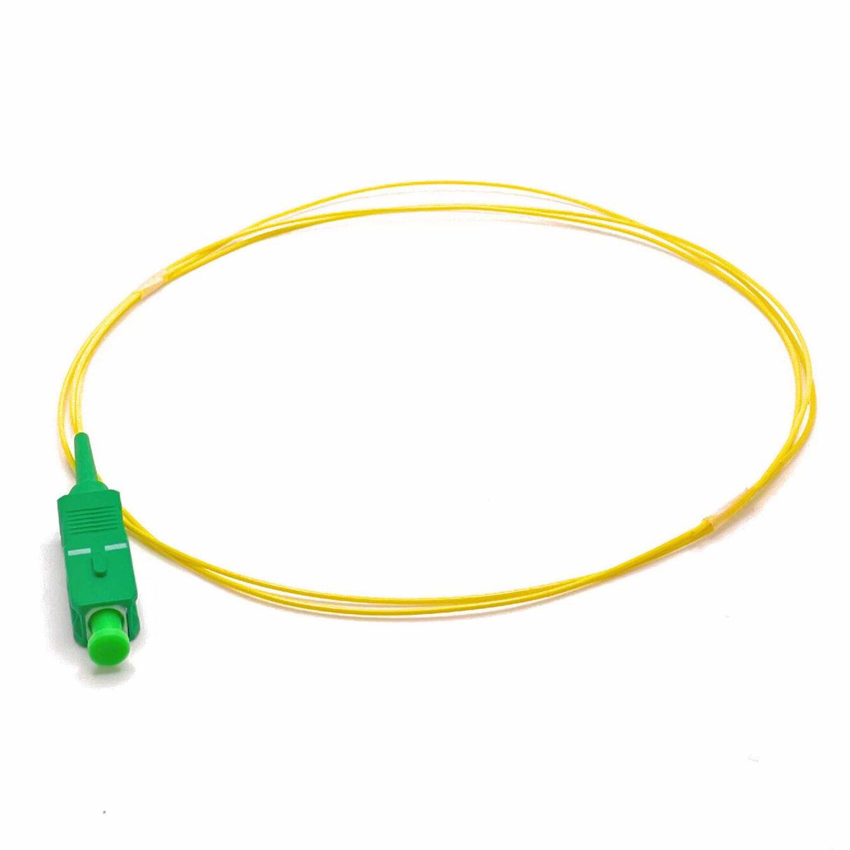 Yellow fiber optic pigtail with green SC APC connector on one end and a buffer coat.